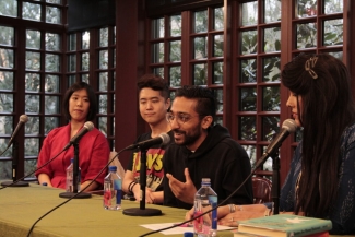 Photograph of a  panel at the Kelly Writers House in April 2023 on Writing Food in Asian America. A young panelist smiles and speaks into the mic as the other panelists look on attentively.