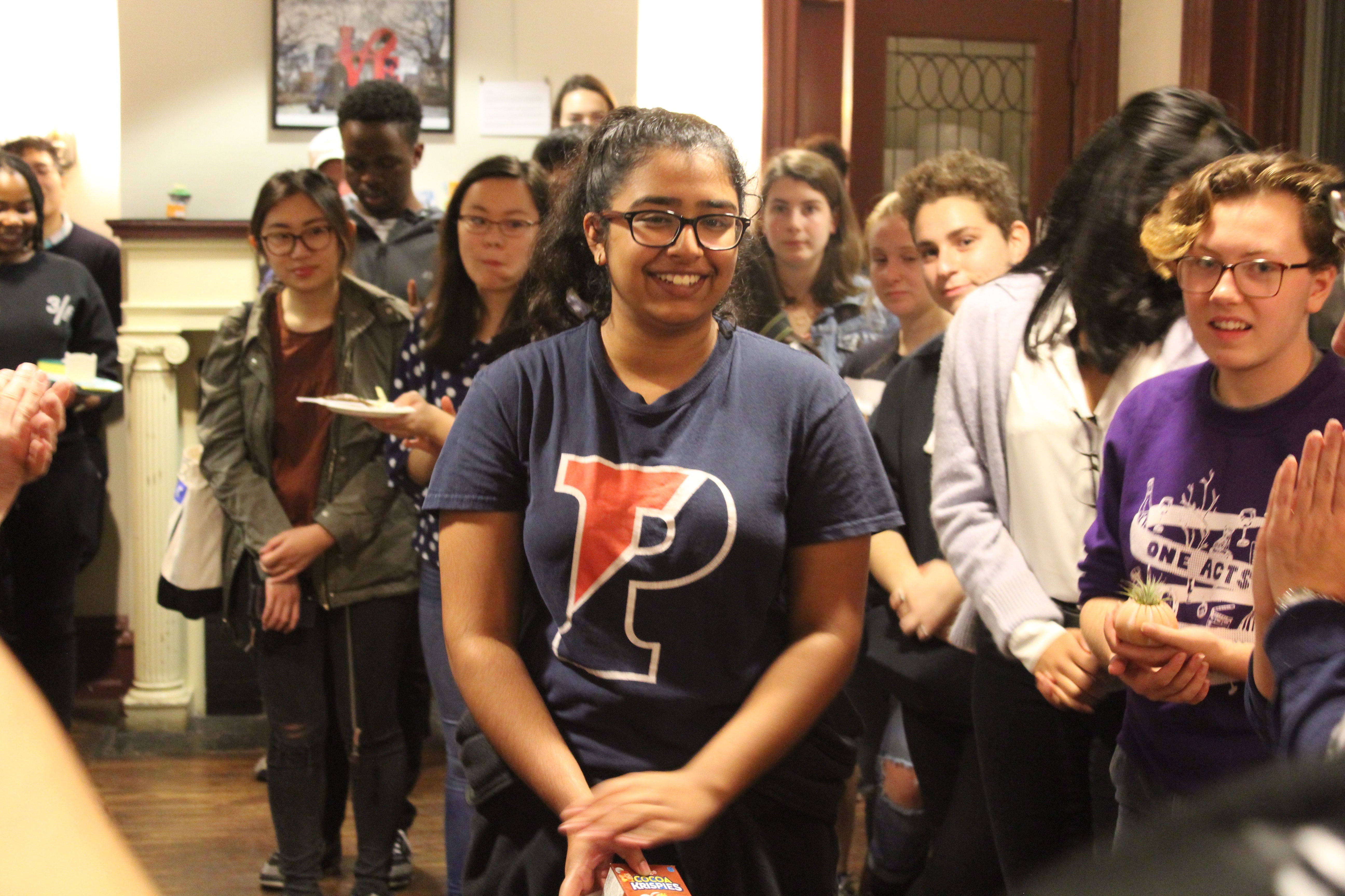 A group of smiling students at the Kelly Writers House