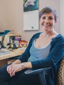 A photograph of Jamie-Lee Josselyn in her office