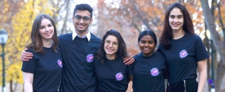 A photograph of the Cosmic Writers leadership team standing arm in arm. From left to right they are: ebekah Donnell, C’24;  Manoj Simha,  W’22; Rowana Miller, C’22;  Abhi Suresh, Bryn Mawr C’24;  and Devi Bass, Penn C’23