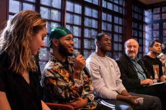 A photograph of students and professors speaking on a panel at Kelly Writers House.