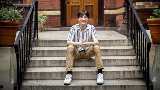 Photograph of Dylan Fritz smiling outside of Penn Press