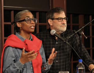 Photograph of Simone White and Al Filreis speaking side by side at the podium at the Kelly Writers House Arts Cafe